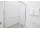 Clean bathroom highlighting a glass-enclosed shower with white tile and chrome fixtures at 1430 Reunion Blvd, Reunion, FL 34747