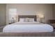 This bedroom has a bed with a padded headboard and 2 lamps on the nightstands at 1430 Reunion Blvd, Reunion, FL 34747