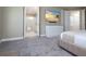 Bedroom view with a modern dresser with television and an open door to the ensuite bathroom at 1430 Reunion Blvd, Reunion, FL 34747