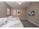Warm bedroom showcasing two beds, carpeted flooring, and Mickey Mouse themed wall art at 1430 Reunion Blvd, Reunion, FL 34747