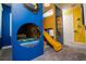 Themed ' bedroom with custom bunkbeds, slide, plush carpet, and vibrant color scheme at 1430 Reunion Blvd, Reunion, FL 34747