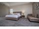 Spacious bedroom with modern decor, plush carpeting, and a cozy chaise lounge for relaxation at 1430 Reunion Blvd, Reunion, FL 34747