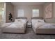 Cozy bedroom featuring two beds with soft throws and neutral decor at 1430 Reunion Blvd, Reunion, FL 34747