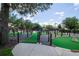 Community putting green with artifical grass and manicured landscaping on a sunny day at 1430 Reunion Blvd, Reunion, FL 34747