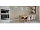 Elegant dining room featuring a wooden table, comfortable seating, and modern lighting fixture at 1430 Reunion Blvd, Reunion, FL 34747