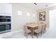 Dining area with modern lighting, a wooden table, and large windows at 1430 Reunion Blvd, Reunion, FL 34747