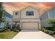 Beautiful exterior of a two-story home with well-maintained landscaping and a two-car garage at 1430 Reunion Blvd, Reunion, FL 34747