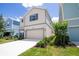 Beautiful exterior of a two-story home with well-maintained landscaping and a two-car garage at 1430 Reunion Blvd, Reunion, FL 34747
