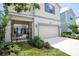 Charming home with a two-car garage, manicured landscaping, and private outdoor patio at 1430 Reunion Blvd, Reunion, FL 34747