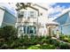 Charming two-story home with teal shutters and nicely landscaped yard at 1430 Reunion Blvd, Reunion, FL 34747