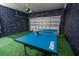 Finished garage featuring an electric door and professional ping pong table at 1430 Reunion Blvd, Reunion, FL 34747