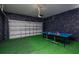 Finished garage featuring an electric door and professional ping pong table at 1430 Reunion Blvd, Reunion, FL 34747