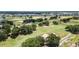 Picturesque view of a sprawling golf course featuring lush greenery, sand traps, and mature trees at 1430 Reunion Blvd, Reunion, FL 34747