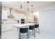 Open-concept kitchen with a center island, modern pendant lighting, and stainless steel appliances at 1430 Reunion Blvd, Reunion, FL 34747
