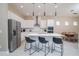 Modern kitchen featuring a spacious island, stainless steel appliances, and elegant pendant lighting at 1430 Reunion Blvd, Reunion, FL 34747