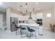 Stylish kitchen with sleek white cabinetry, stainless steel appliances, and a large central island at 1430 Reunion Blvd, Reunion, FL 34747