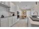 Well-equipped kitchen with white cabinets, subway tile backsplash, and adjacent dining area at 1430 Reunion Blvd, Reunion, FL 34747