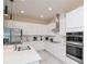 Well-equipped kitchen with stainless steel appliances, white cabinetry, and ample counter space at 1430 Reunion Blvd, Reunion, FL 34747