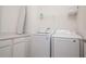 Bright laundry room featuring Samsung washer and dryer, storage, and countertop space for folding and organizing laundry at 1430 Reunion Blvd, Reunion, FL 34747