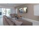 Bright living room showcasing comfortable seating, a modern television, and sliding doors to the pool area at 1430 Reunion Blvd, Reunion, FL 34747