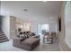 Spacious living room featuring a modern sectional sofa, stylish decor, and sliding doors to the outdoor area at 1430 Reunion Blvd, Reunion, FL 34747