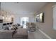 Inviting living room with a comfortable sectional sofa, wall-mounted TV, and open layout to the kitchen and dining area at 1430 Reunion Blvd, Reunion, FL 34747