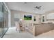 Bright living room with tile floors, ceiling fan, and sliding doors to outdoor patio at 1430 Reunion Blvd, Reunion, FL 34747