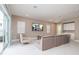 Bright and airy living room features a comfortable seating area, access to the outdoors, and built-in desk space at 1430 Reunion Blvd, Reunion, FL 34747
