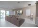 Bright living room boasts a sectional sofa, backyard pool access, and open layout at 1430 Reunion Blvd, Reunion, FL 34747