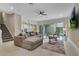 Spacious living room features tile floors, modern ceiling fan, and sliding glass doors to the pool area at 1430 Reunion Blvd, Reunion, FL 34747