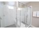 This is a walk in shower with white tiling and a glass enclosure and a shower bench at 1430 Reunion Blvd, Reunion, FL 34747