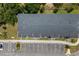 An aerial view shows the unit's roof, neighboring trees, and parking area at 3428 Tranquil Trail, Kissimmee, FL 34747