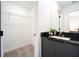 Bright bathroom featuring a walk-in closet, modern vanity, and ensuite bathroom at 3428 Tranquil Trail, Kissimmee, FL 34747