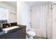 Modern bathroom with dark cabinets, neutral walls, and a combined shower and bathtub at 3428 Tranquil Trail, Kissimmee, FL 34747