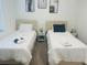 Clean and bright bedroom featuring two twin beds with fresh white linens and simple decor at 3428 Tranquil Trail, Kissimmee, FL 34747