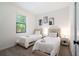 Bright bedroom featuring two twin beds, neutral decor, and a window that lets in ample natural light at 3428 Tranquil Trail, Kissimmee, FL 34747