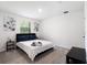 Neutral bedroom featuring a king-size bed and natural light from window at 3428 Tranquil Trail, Kissimmee, FL 34747