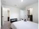 Bright bedroom featuring a walk-in closet, ensuite bathroom, and neutral decor at 3428 Tranquil Trail, Kissimmee, FL 34747