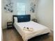 Comfortable bedroom featuring a queen bed, stylish decor, and soft carpeting at 3428 Tranquil Trail, Kissimmee, FL 34747