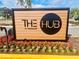 Well-maintained community sign with colorful flowers and greenery, announcing 'The Hub at Westside' at 3428 Tranquil Trail, Kissimmee, FL 34747