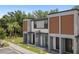 Modern townhouse featuring a combination of wood accents and concrete, in a landscaped setting at 3428 Tranquil Trail, Kissimmee, FL 34747