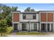 Modern townhome with a neutral color scheme, offering a stylish and contemporary curb appeal at 3428 Tranquil Trail, Kissimmee, FL 34747