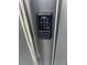 Close-up of a Kwikset digital keypad lock on a gray front door with silver hardware for keyless entry at 3428 Tranquil Trail, Kissimmee, FL 34747