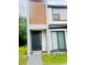Modern facade featuring a dark front door and well-manicured walkway leading to entry at 3428 Tranquil Trail, Kissimmee, FL 34747