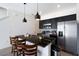 Modern kitchen featuring stainless steel appliances, a granite countertop island, and pendant lighting at 3428 Tranquil Trail, Kissimmee, FL 34747