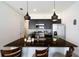 Stylish kitchen with stainless steel appliances, dark cabinets, granite countertops, and modern pendant lights at 3428 Tranquil Trail, Kissimmee, FL 34747