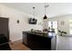 Open-concept kitchen with granite countertops, stainless steel appliances, and a functional breakfast bar at 3428 Tranquil Trail, Kissimmee, FL 34747
