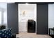 Laundry closet with a white washing machine and black dryer behind dark sliding doors at 3428 Tranquil Trail, Kissimmee, FL 34747