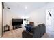 Cozy living room featuring comfortable seating, large TV, and neutral décor at 3428 Tranquil Trail, Kissimmee, FL 34747