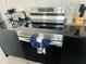 Close-up of a stainless steel oven with a modern stovetop and dark cabinets, showing a sleek kitchen design at 3428 Tranquil Trail, Kissimmee, FL 34747